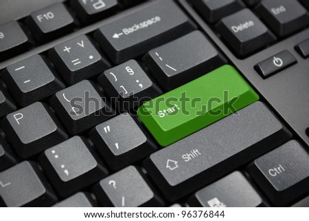 green start button on black computer keyboard