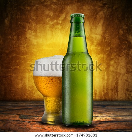 Bottle and Glass of Cold Beer with vintage background