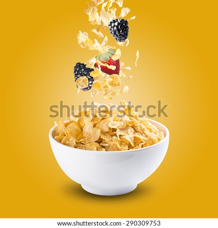 Corn Flakes With Strawberry and Blackberry Falling into A Bowl of Milk Splash