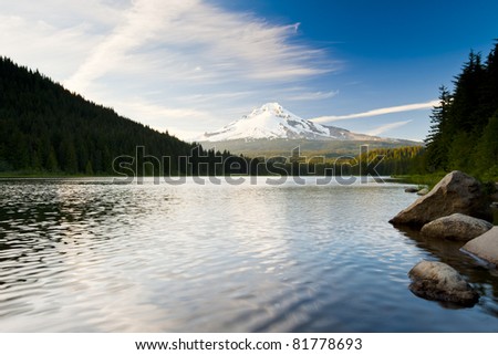 The volcano mountain Mt. Hood, in Oregon, USA. At sunset with reflection on the water of the Trillium lake.