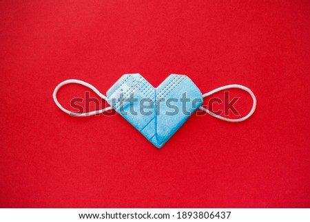 valentine's day during the coronavirus covid pandemic, 14 February 2021. medical mask valentine