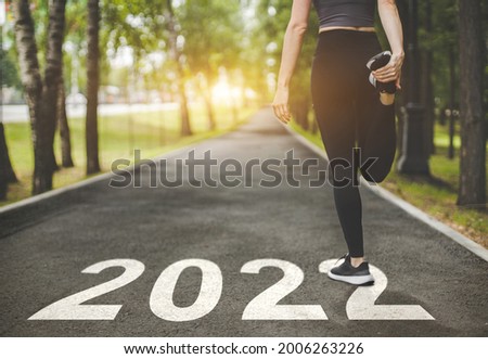female feet in sneakers at the start. Beginning and start of the new year 2022, goals and plans for the next year