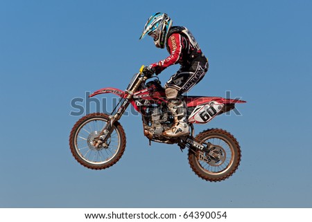 BLOEMFONTEIN, SOUTH AFRICA - JULY 19: Unidentified motocross rider jumps through the air during a national motocross racing event, on Jul 19, 2009 in Bloemfontein, South Africa.