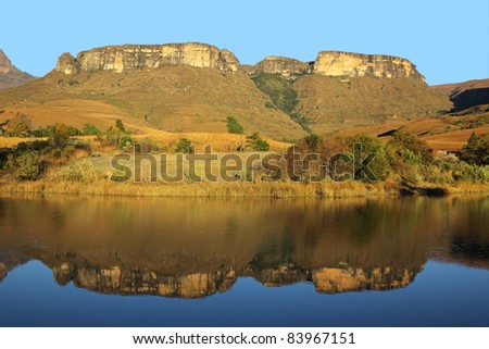 Sandstone mountains with symmetrical reflection in water, Royal Natal National Park, South Africa