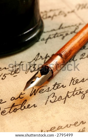 Vintage nib pen and inkwell, on a page of 18th century script.