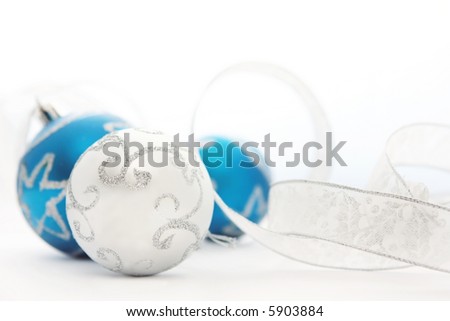 Blue and Silver Christmas baubles, with silver ribbon.  Soft focus, shallow depth of field.