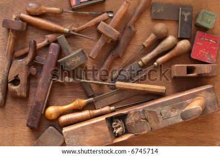 Vintage woodworking tools, including planes, chisels, whittling tools
