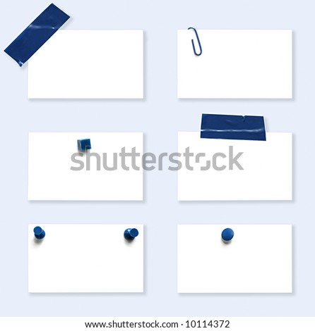 Blank white labels with various blue fasteners.  Tape, paperclip, pushpins, drawing pins.