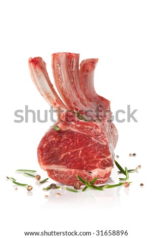 Rack of lamb, isolated on white.  Frenched lamb cutlets with rosemary and peppercorns, ready for cooking.
