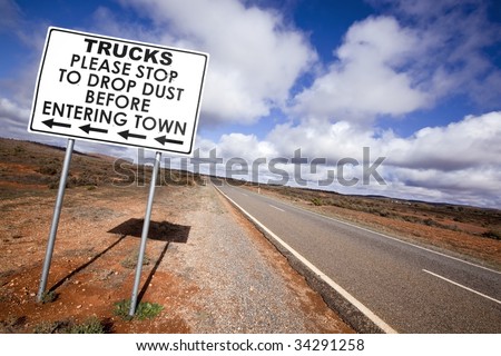 Road sign in the Australian outback, asking trucks to stop to drop dust before entering town.  Outside Broken Hill, in western New South Wales.
