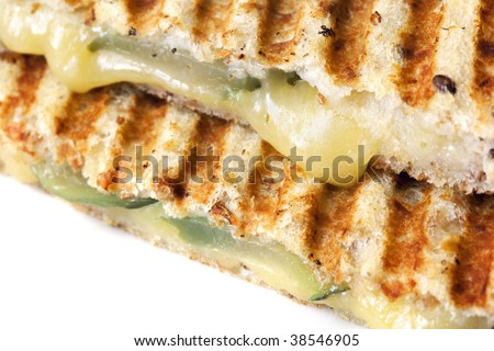 Close-up of grilled cheese and pickle sandwich, with melting Colby cheese.