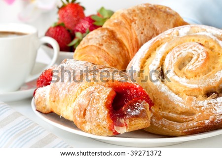 Continental breakfast with assortment of pastries, coffees and fresh strawberries.