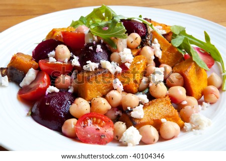 Vegetarian salad with chickpeas, baby beets, roasted pumpkin, cherry tomatoes, red onion, rocket and feta cheese.  Delicious healthy eating.