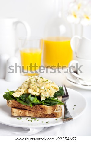 Scrambled eggs on toast, with wilted spinach.