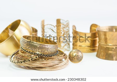 Beautiful expensive gold bracelets and ring on white background