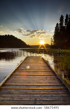 dramatic sunset of a lake looking off a dock