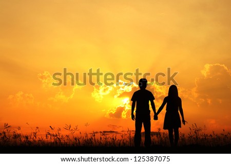 Man and Woman love silhouette in sunset