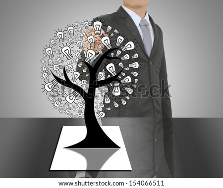 Business man writing concept of Paper light bulb tree