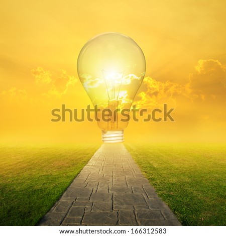 Concrete road and Big idea bulb in Grass fields and Sunset