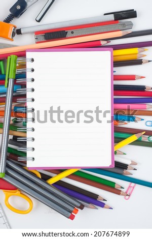 Notebook and school or office tools on white background