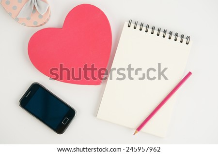 Pink Heart gift box phone and notebook on white background