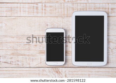 Tablet and phone  on white wood.Copy space