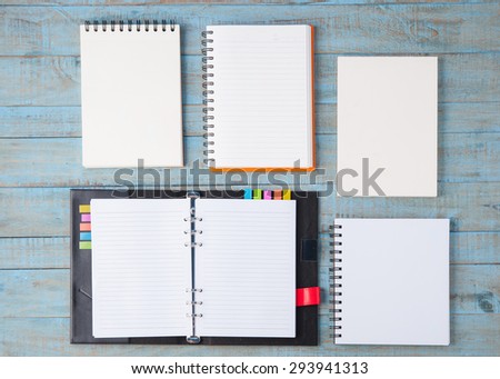 Notebook on blue wood table  for text and background
