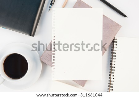Cup of hot coffee tablet phone and diary notebook on white background for text and background.Copy space