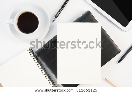 Cup of hot coffee tablet phone and diary notebook on white background for text and background.Copy space