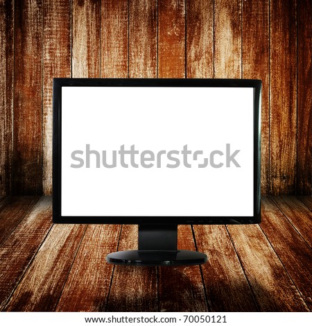 LCD monitor on wood floor and wall