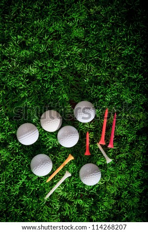 golf ball driver and tee on green grass field