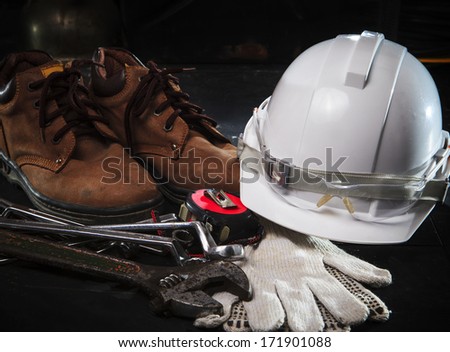 safety shoe and safety helmet with construction equipment with low key light use for construction industry topic