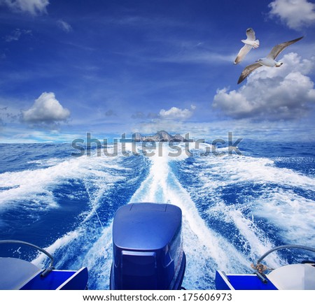 rear view of speed boat leaving from lonely island against blue sky background use for holiday sea and ocean destination