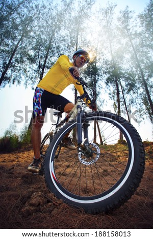 young man riding mountain bike mtb in jungle track use for sport extreme adventure healthy and holiday activities life style
