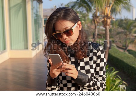 portrait of young woman reading message on mobile phone use for modern digital connecting technology