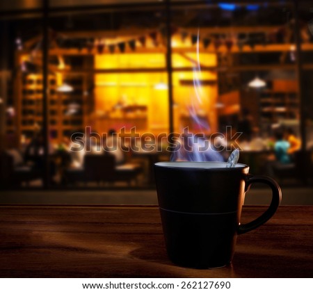 hot coffee cup on wood table in coffee cafe shop use for food and drink in modern restaurant