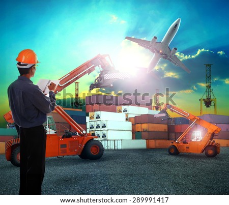 working man in logistic business working in container shipping yard with dusky sky and jet plane cargo flying above use for land to air transport and freight