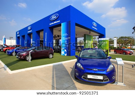 BANGKOK - JANUARY 10: A new Ford Fiesta sedan is on display in front of the Ford booth at BOI FAIR 2011 on January 10, 2012 in Bangkok, Thailand