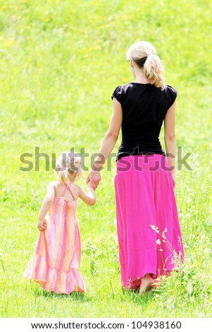 a young mother with her daughter on the nature