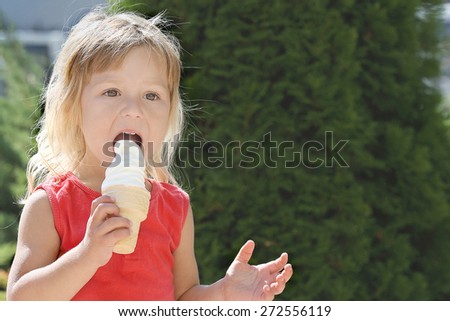 beautiful little girl with ice cream on the nature