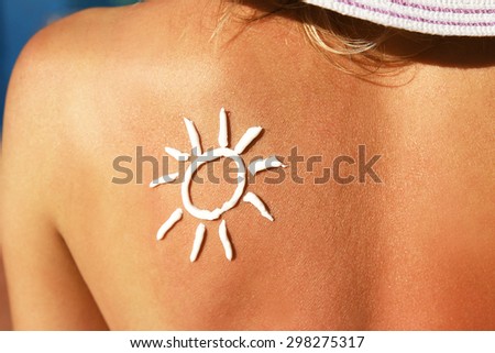 from sun cream on the female back of the swimming pool
