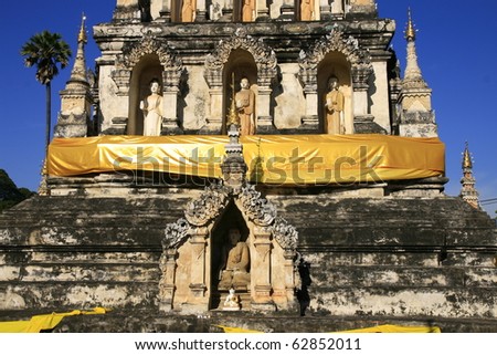 monk sculpture in pyramidal Pagoda ruin in northern region Thailand