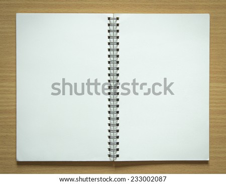 blank spiral notepad on wood background
