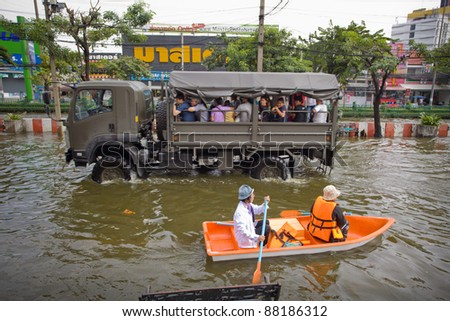 BANGKOK, THAILAND - NOVEMBER 5: People uses boat as a transportation through water during the worst flooding in decades on November 5,2011 Bangkok, Thailand.
