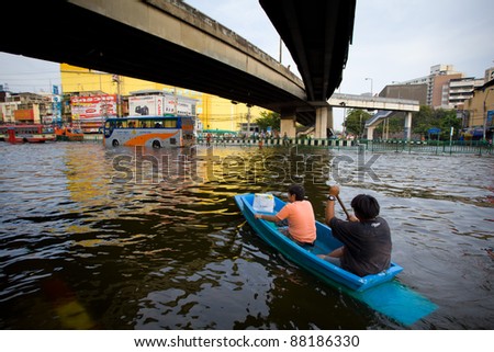BANGKOK, THAILAND - NOVEMBER 5: People uses boat as a transportation through water during the worst flooding in decades on November 5,2011 Bangkok, Thailand.