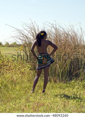 African American woman outdoors green skirt no top from back