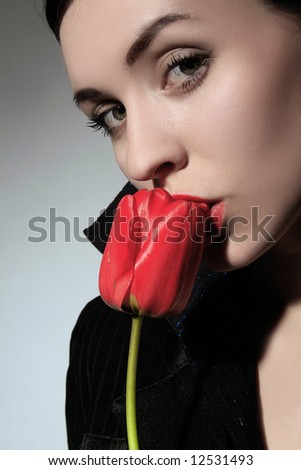 a business woman is holding red flower