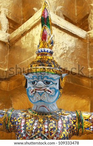 Blue sad giant statue in Emerald Buddha Temple, Bangkok, Thailand