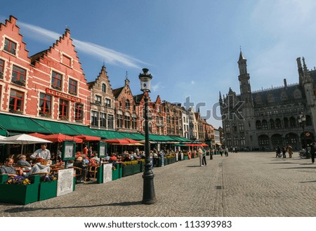 BRUGES - MAY 17:  Medieval style shops and restaurants around the market place (Grote Markt) on May 17, 2010 in Bruges, Belgium. The market place is free from traffic since October 1996.