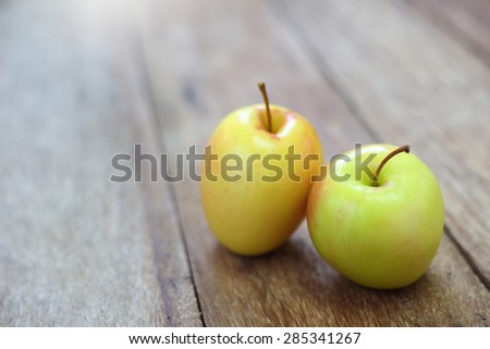 yellow apple on wood table